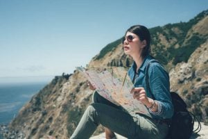 Asian-woman-looking at map at top of mountain | Princeton Nutrients